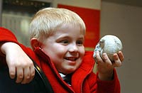 Jacob Chash with an ammonite fossil at the Corinium Museum in Cirencester