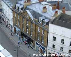 The large building in the center of the photograph is Next which overlooks the Market Place in the heart of Cirencester